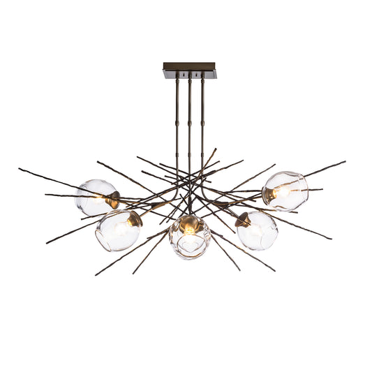 A modern Griffin Pendant with a brass finish and clear glass balls, featuring Hubbardton Forge lighting.