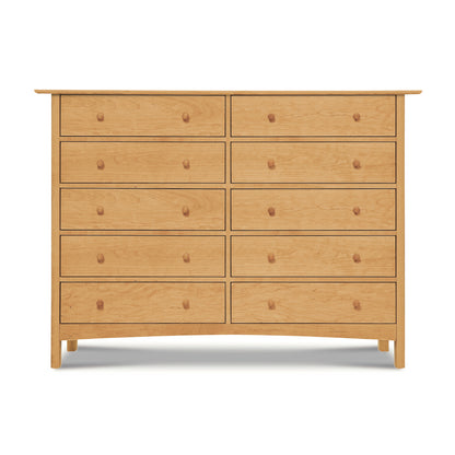 Light solid wood dresser with ten classic-style drawers and round knobs, exemplifying the timeless elegance of the Heartwood Shaker Collection by Vermont Furniture Designs.