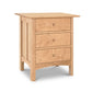 A Vermont Furniture Designs Heartwood Shaker 3-Drawer nightstand crafted from luxury wood with three drawers.