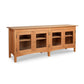 Heartwood Shaker 4-Door Console Bookcase by Vermont Furniture Designs showcasing a light brown finish with glass doors and shelves.