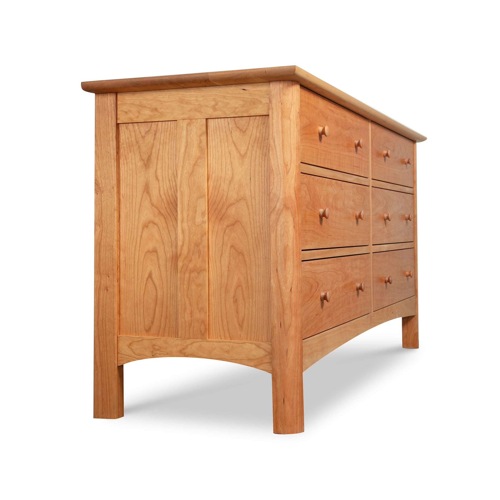 Heartwood Shaker 6-Drawer Dresser by Vermont Furniture Designs, crafted from solid hardwood with a natural finish, highlighted from a low angle.