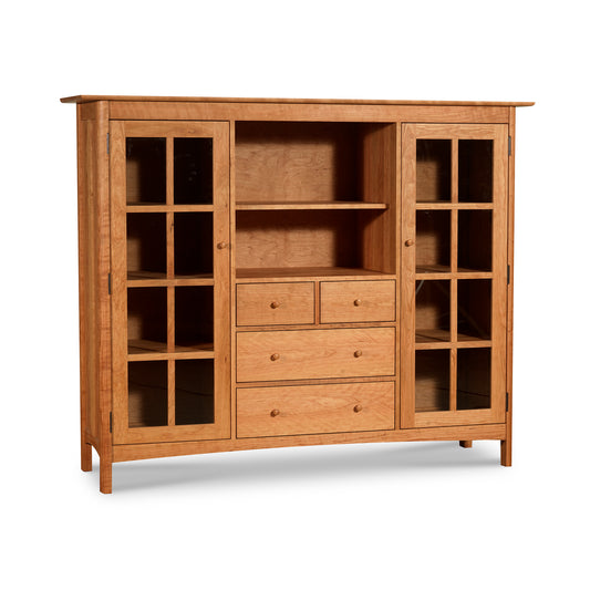 A Vermont Furniture Designs Heartwood Shaker Home Office Center Cabinet featuring a solid wood bookcase with glass doors on the sides, drawers in the center, and open shelves on a white background.