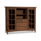 A Vermont Furniture Designs Heartwood Shaker Home Office Center Cabinet featuring glass-paneled doors on the sides with a central section consisting of open shelves and drawers.
