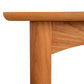 Close-up of a Vermont Furniture Designs Heartwood Shaker End Table corner showing the tabletop, edge, and a leg with visible wood grain details against a white background.