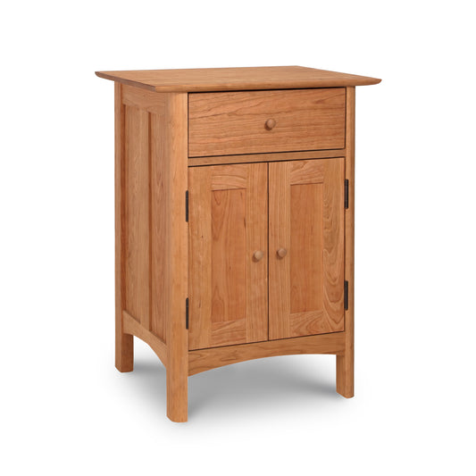Wooden cabinet with a single drawer and double doors, isolated on a white background, transforms into a Vermont Furniture Designs Heartwood Shaker Short Storage Chest.