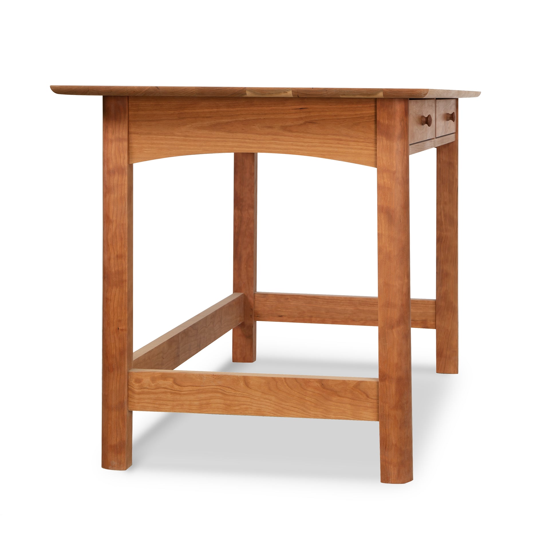 A Heartwood Shaker Writing Desk by Vermont Furniture Designs, featuring a rectangular top and four legs, isolated on a white background.