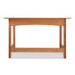 A Heartwood Shaker Writing Desk handcrafted by Vermont Furniture Designs with sustainable cherry wood, a flat top and four legs against a white background.