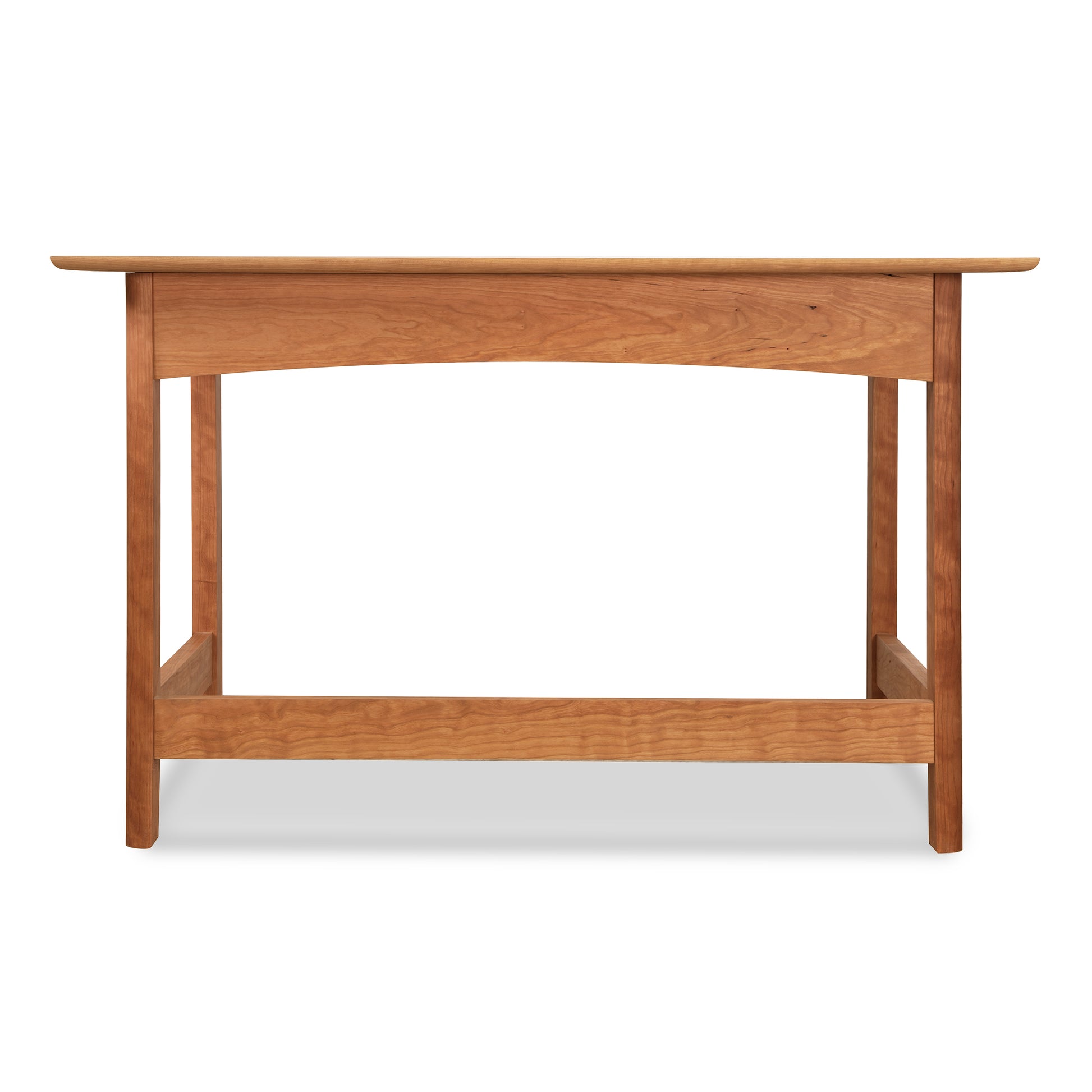A Heartwood Shaker Writing Desk handcrafted by Vermont Furniture Designs with sustainable cherry wood, a flat top and four legs against a white background.