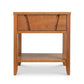 A Lyndon Furniture wooden nightstand with a Holland 1-Drawer Open Shelf Nightstand on top, providing storage.