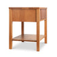 A Lyndon Furniture Holland 1-Drawer Open Shelf Nightstand with an open shelf for storage.