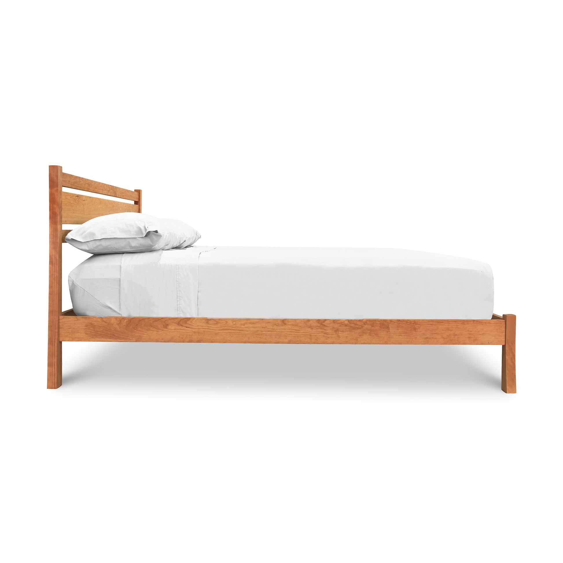 A contemporary Horizon Platform Bed with white sheets, featuring Arts and Crafts styling, made by Vermont Furniture Designs.