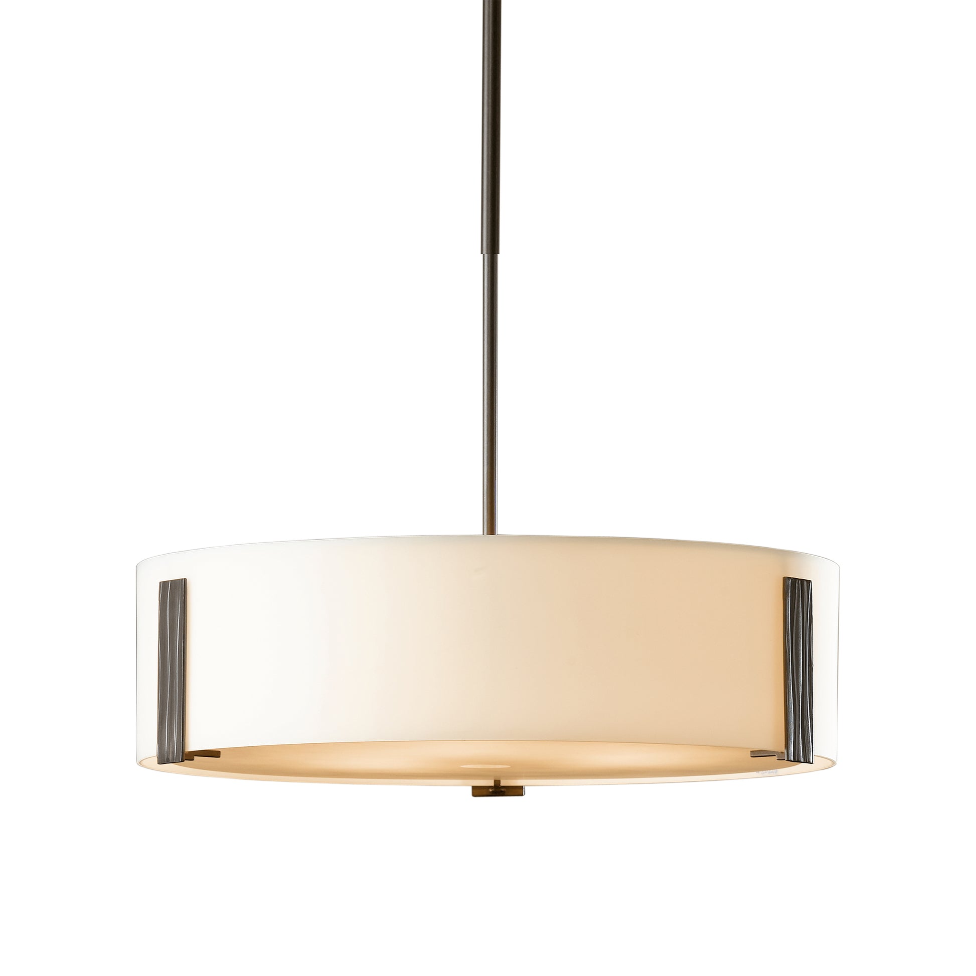 A Hubbardton Forge Impressions pendant, a modern hand-forged lighting fixture with a white shade.