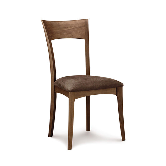 A wooden dining chair with brown leather upholstered seat.