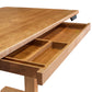Description: An Invigo Cherry Sit-Stand Desk from Copeland Furniture, with a drawer under it, providing office comfort.