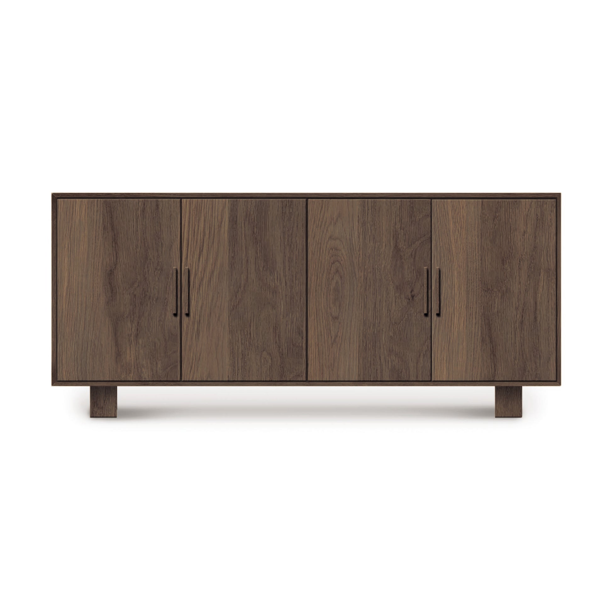 A mid-century modern, wooden Iso 4-Door Buffet with closed cabinets, featuring a simple design with visible wood grain, positioned against a white background by Copeland Furniture.