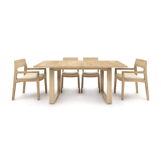 A modern Iso Extension dining table set from Copeland Furniture with four matching chairs arranged symmetrically on a white background.