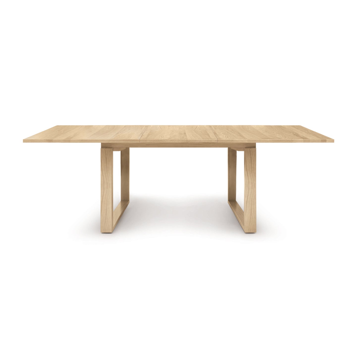 An Iso Extension Dining Table with a solid oak wood base by Copeland Furniture.