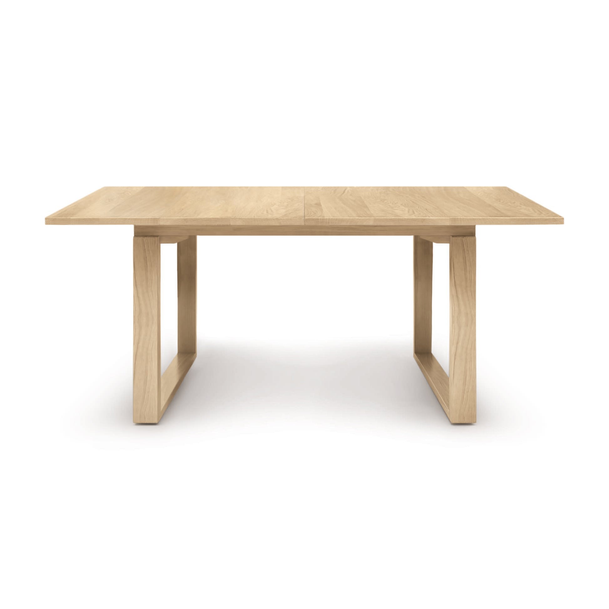A Iso Extension Dining Table with a wooden base by Copeland Furniture.