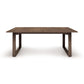 A rectangular Iso Extension Dining Table with a Copeland Furniture wooden base, made of solid oak wood.