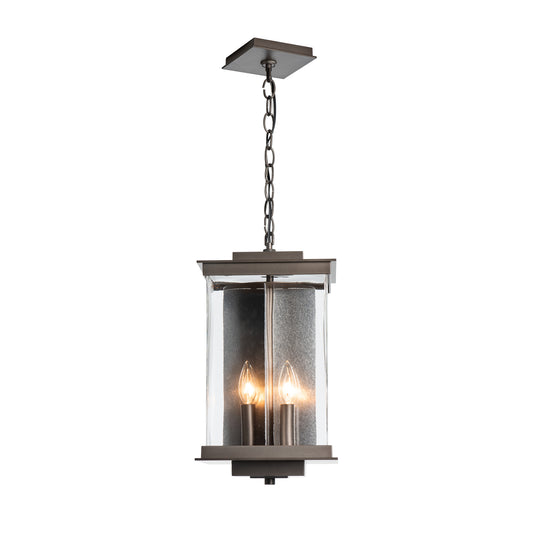 Kingston Outdoor Large Lantern by Hubbardton Forge with metal frame, clear glass panels, and candle-style bulbs, showcasing elegant outdoor lighting craftsmanship.