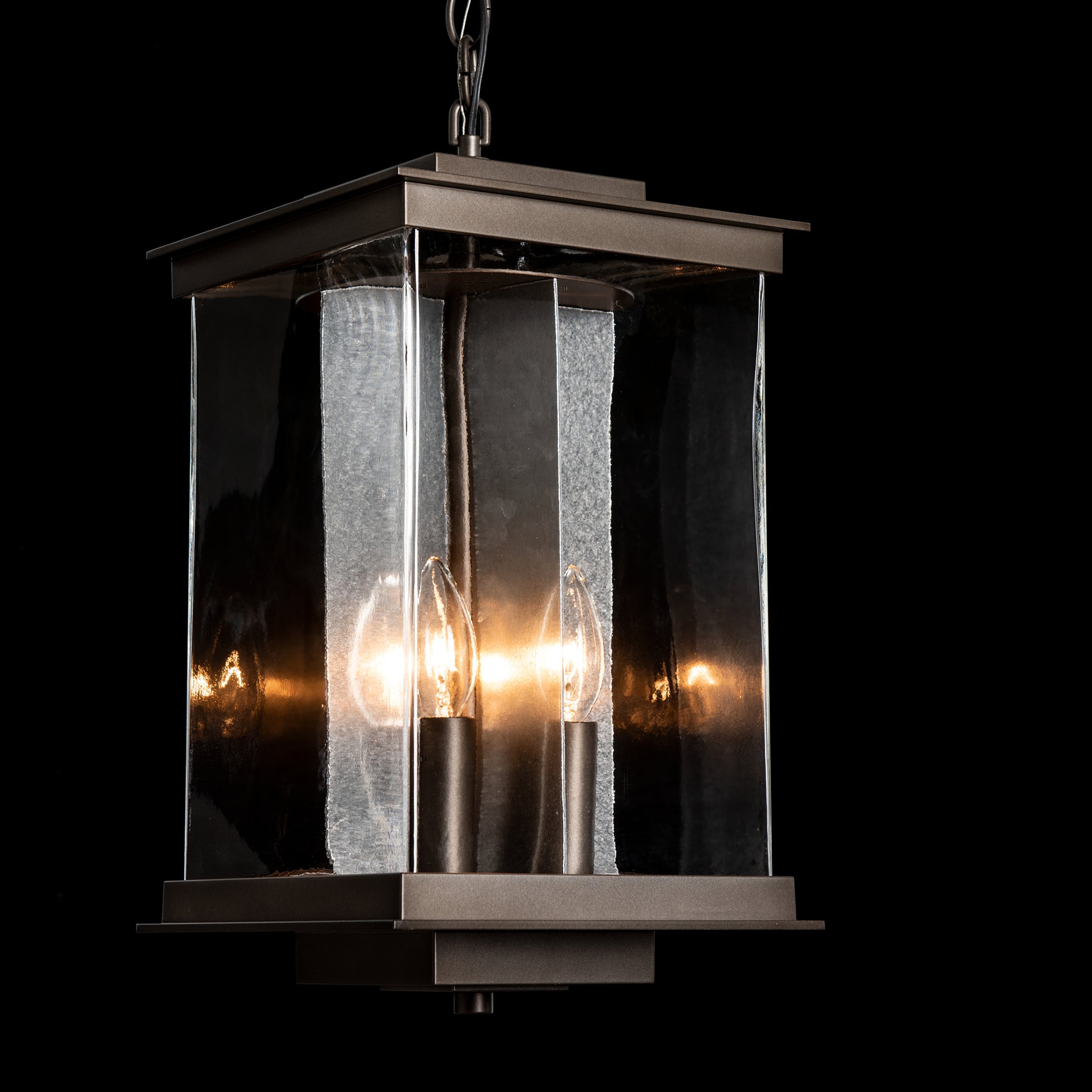 Kingston Outdoor Large Lantern by Hubbardton Forge with metal and glass frame, showcasing two candle-style bulbs, designed for stylish outdoor illumination.