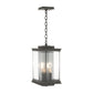 Hubbardton Forge Kingston Outdoor Large Lantern featuring black metal, glass, and three candle-style bulbs suspended on a chain.