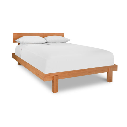 A stylish Kipling Bed made of hardwoods with white sheets on it, by Vermont Furniture Designs.