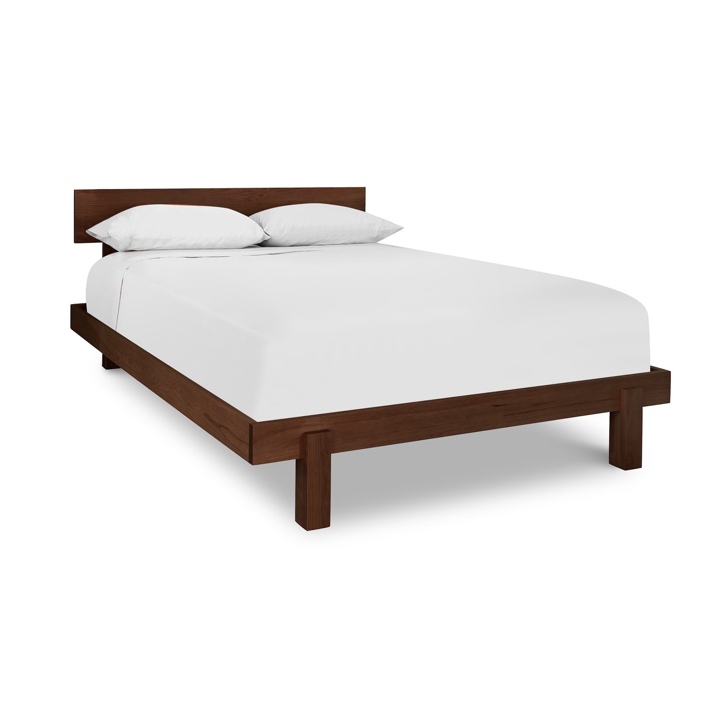 A Kipling Bed by Vermont Furniture Designs with a wooden frame and white sheets made from solid wood.