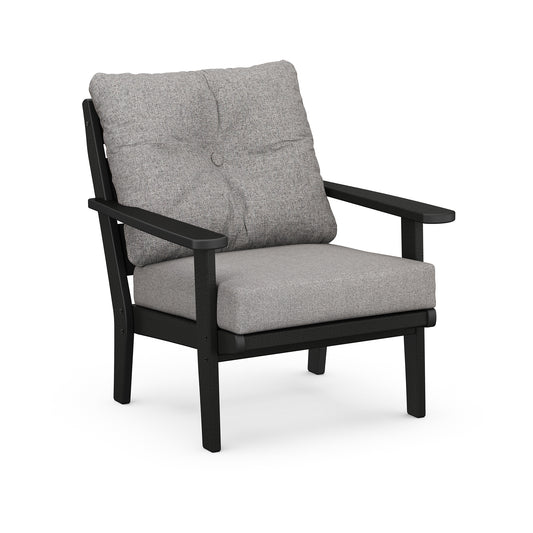A modern POLYWOOD® Lakeside Deep Seating Chair with a black frame and light grey cushions displayed against a white background. The chair features a high back cushion with a button detail.