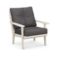 Modern armchair with a light wood frame and dark gray cushions, featuring a minimalist design isolated on a white background, suitable as all-weather outdoor seating, the POLYWOOD Lakeside Deep Seating Chair.
