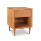 The Larssen 1-Drawer Enclosed Shelf Nightstand by Vermont Furniture Designs is a small wooden nightstand with a drawer, featuring the natural hardwoods and a stylish mid-century modern design.