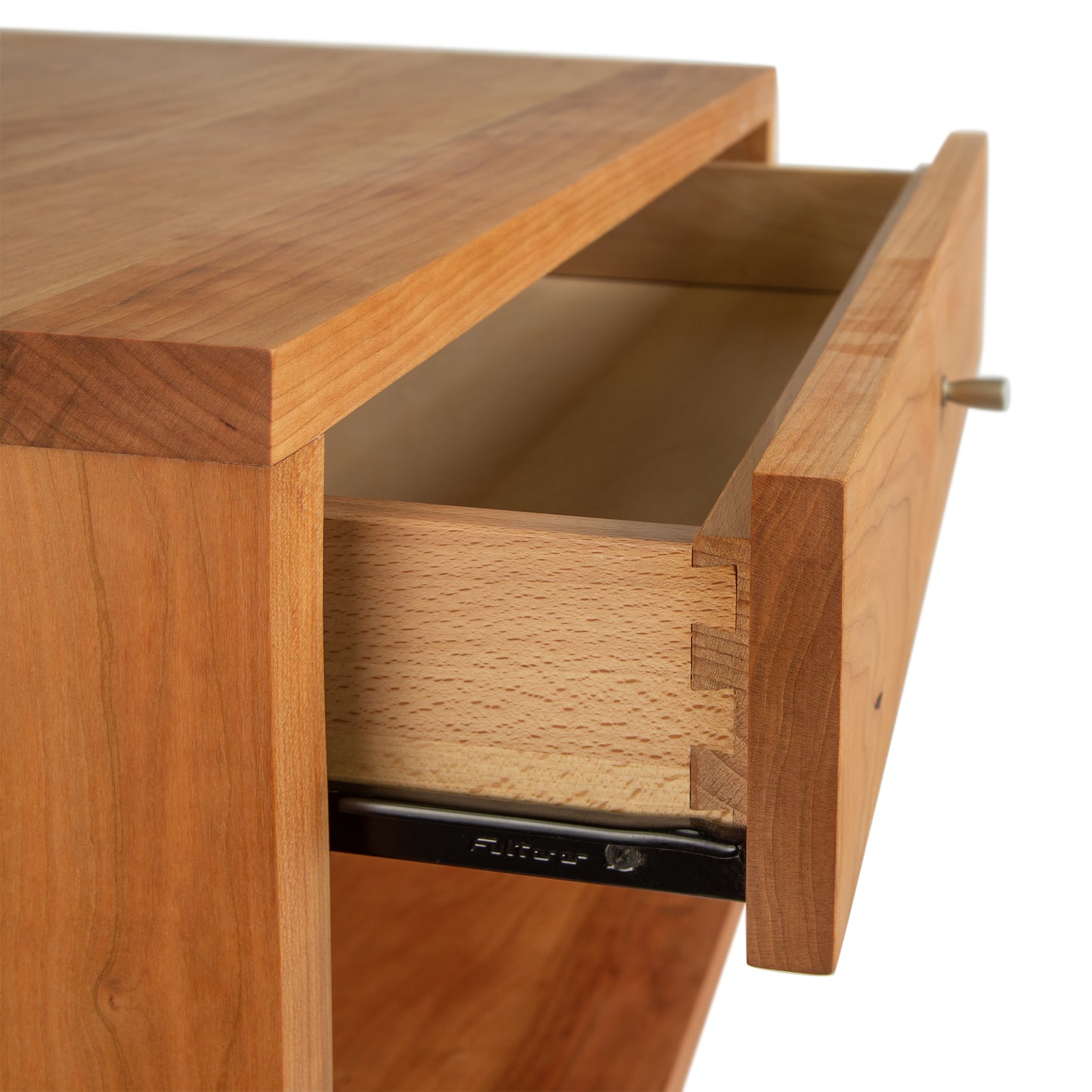 A close up of a Larssen 1-Drawer Wide Nightstand in natural cherry wood as part of the Vermont Furniture Designs Collection.