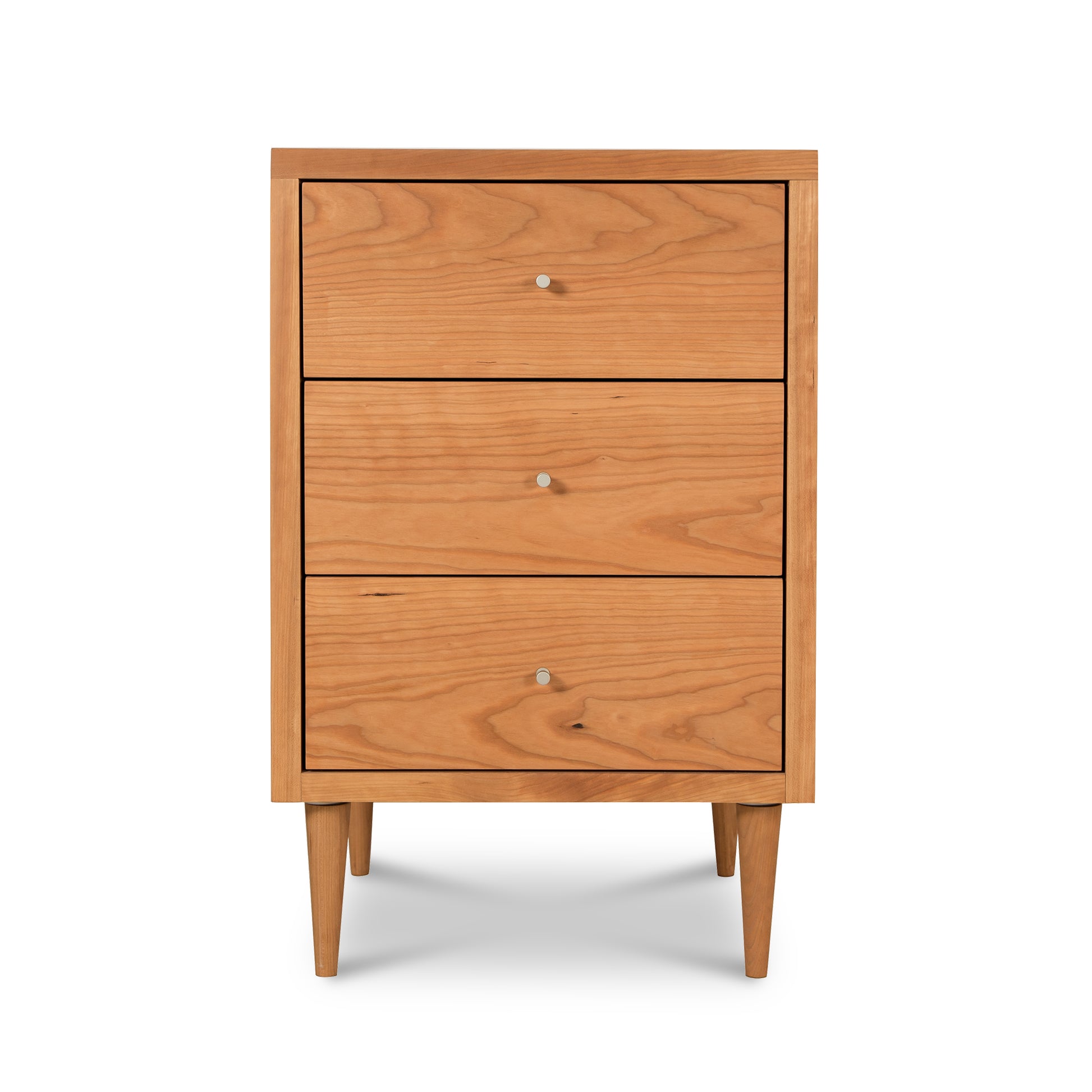 A mid-century modern Vermont Furniture Designs Larssen 3-Drawer Nightstand with tapered legs isolated on a white background.