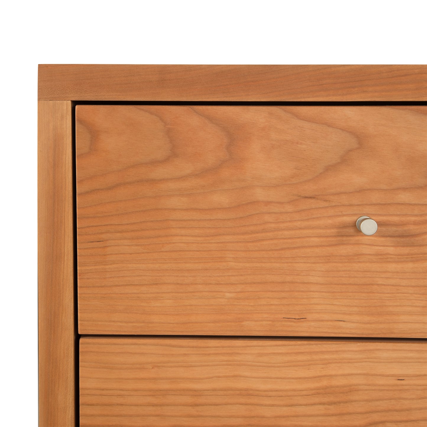 Close-up of the Vermont Furniture Designs Larssen 3-Drawer Nightstand drawer, showcasing the wood grain and joinery with a simple knob, crafted from natural hardwoods.
