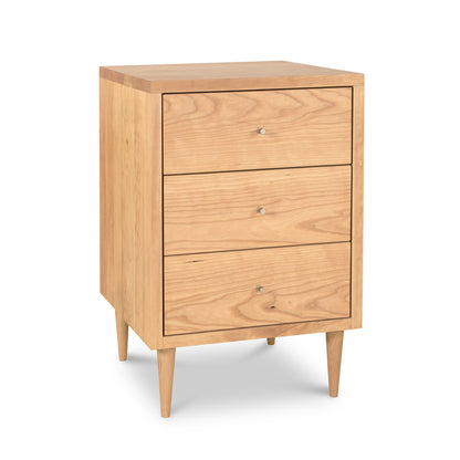 3-drawer nightstand from Vermont Furniture Designs' Larssen Collection with round knobs, tapered legs, and a natural finish.