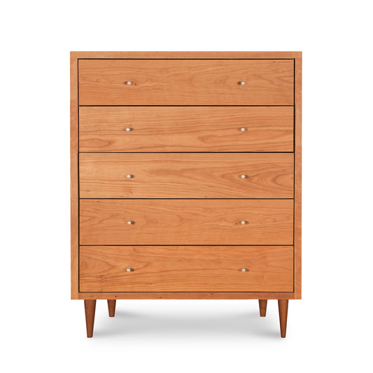 A Vermont Furniture Designs Larssen 5-Drawer Wide Chest with round handles and tapered legs, isolated on a white background.