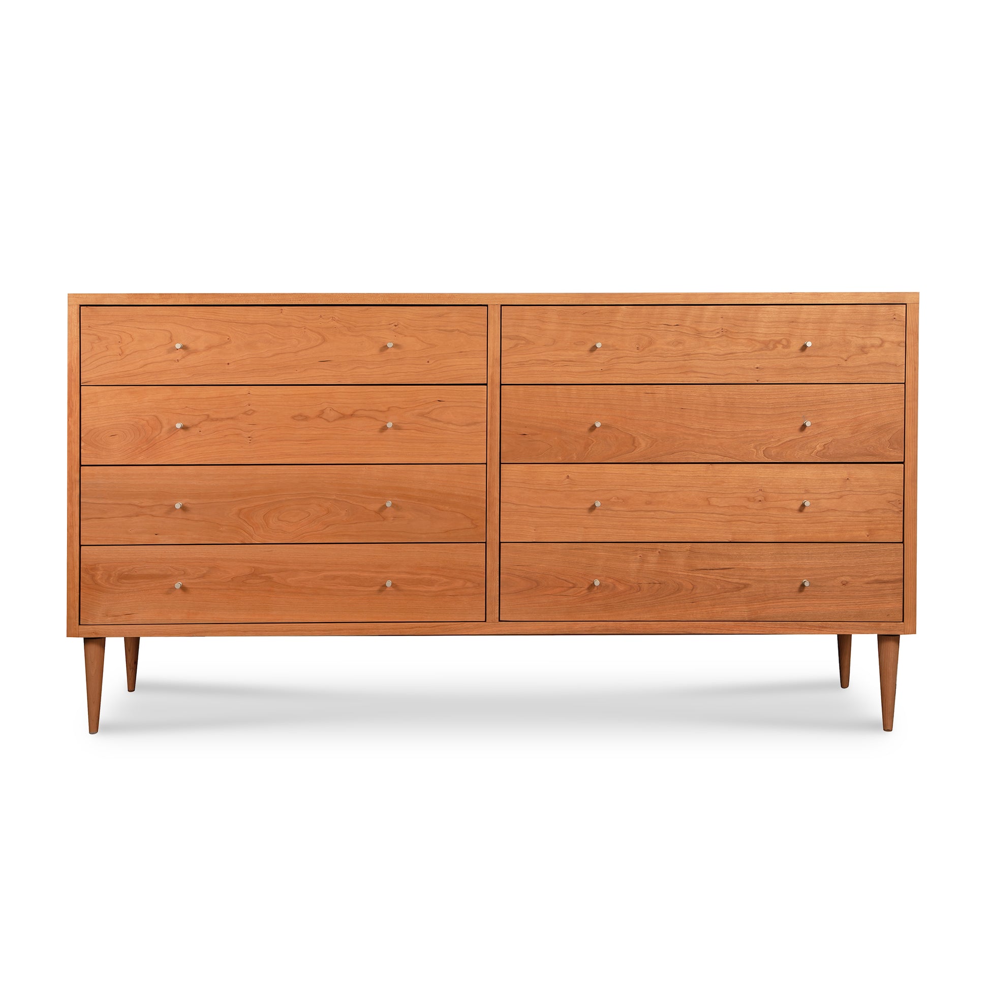 A Larssen 8-Drawer Dresser - Clearance crafted from natural solid hardwood with eight drawers and round handles, set on four tapered legs, against a white background.