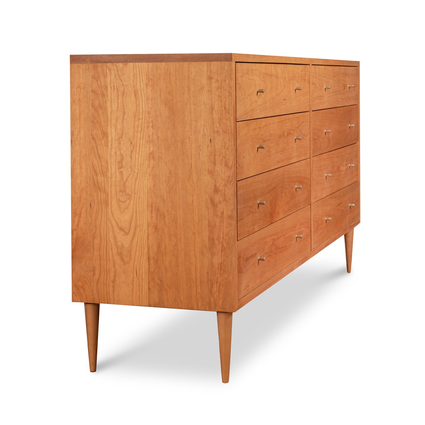 A mid-century modern Larssen 8-Drawer Dresser - Clearance crafted from natural solid hardwood with multiple drawers and tapered legs, isolated on a white background.