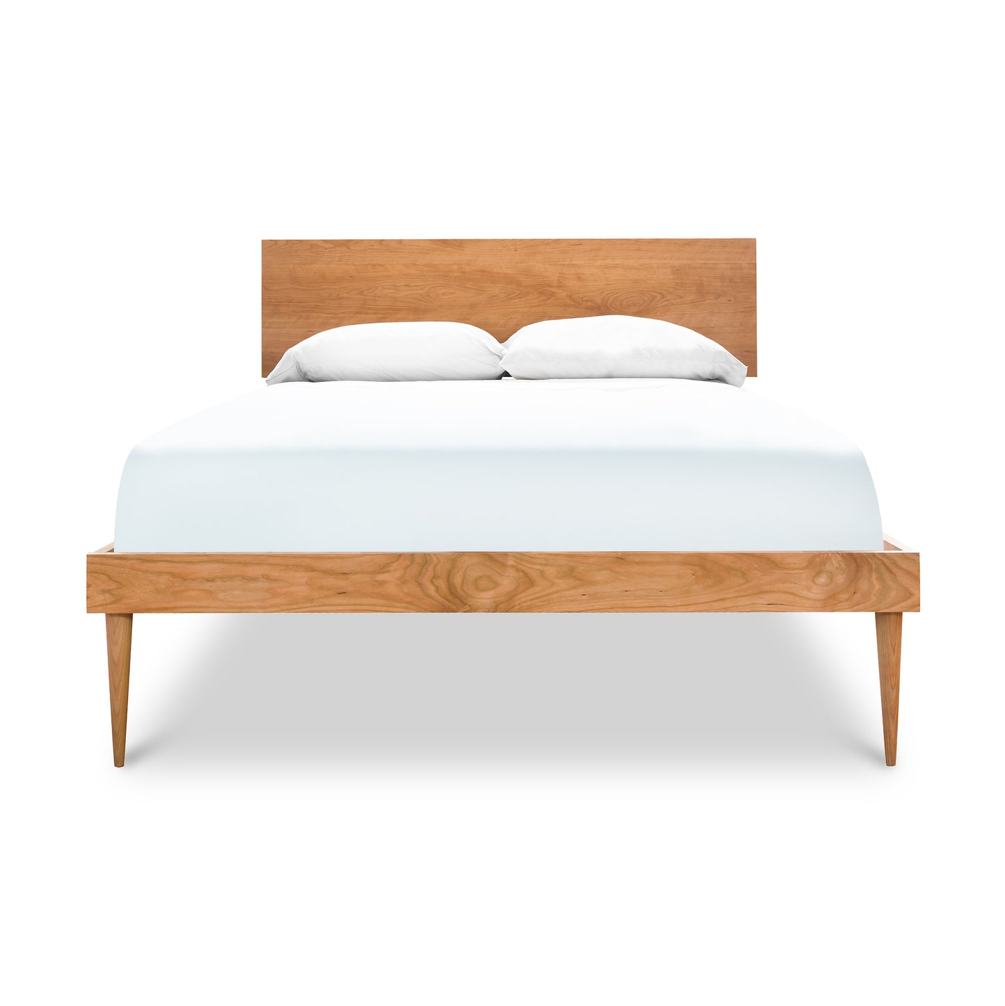 Alt text: American made Larssen Queen Bed by Vermont Furniture Designs - solid wood frame with simple headboard and tapered legs, featuring neatly made white linens and two pillows. Minimalistic and modern design, perfect for contemporary bedrooms with Arts and Crafts styling influences.