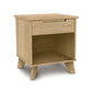 A sustainable Linn 1-Drawer Enclosed Shelf Nightstand with an open shelf and a closed drawer on a white background, crafted by Copeland Furniture.