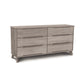 A Linn 6-Drawer Dresser by Copeland Furniture in a light gray finish, isolated on a white background.