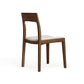 Lisse Dining Chair by Copeland Furniture features a handcrafted wood frame, rectangular backrest, and light cushion upholstery.