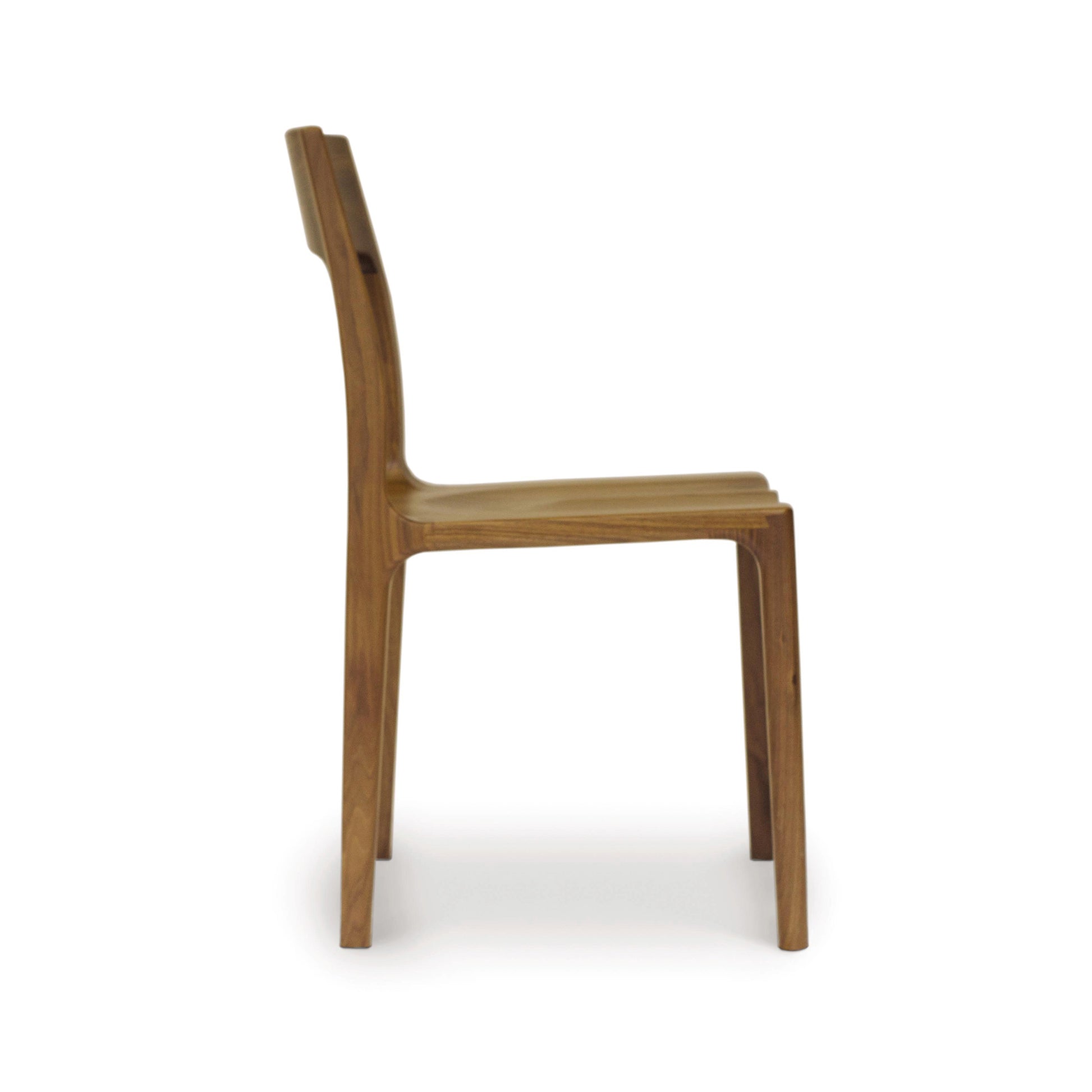 A walnut Lisse Dining Chair from the Copeland Furniture Collection, with a curved backrest and seat, isolated on a white background.