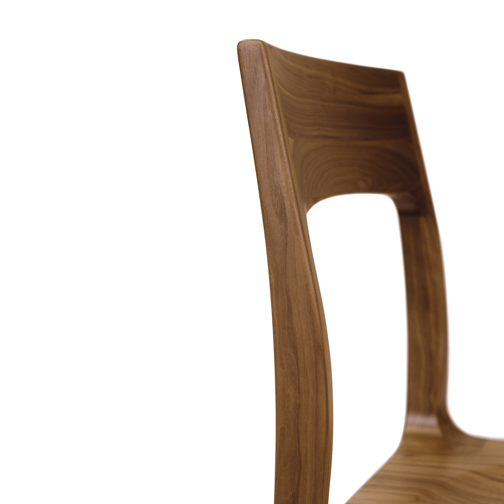 A close up of a wooden chair on a white background.