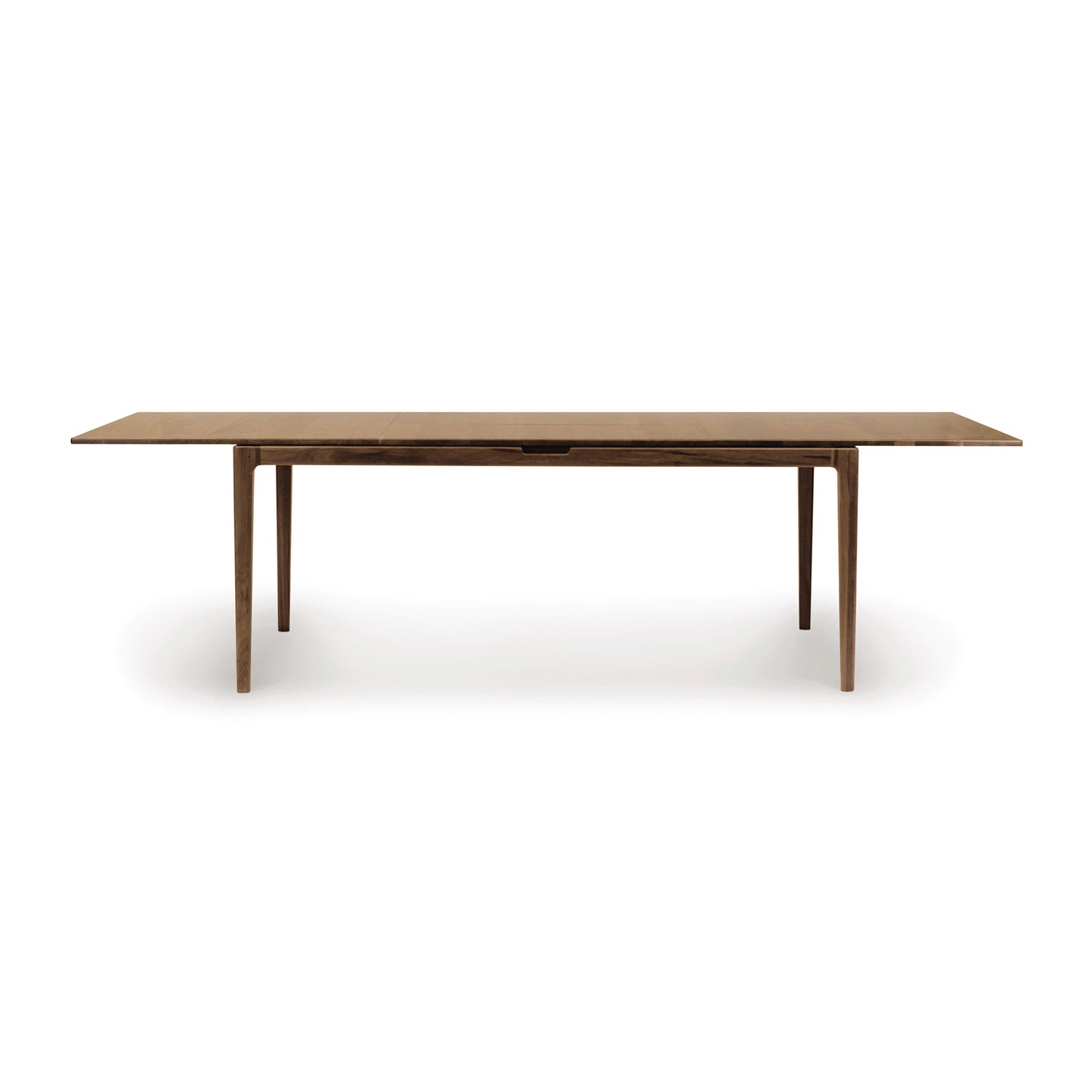 An eco-friendly Lisse Extension Dining Table, crafted from solid walnut construction, with thin legs on a white background by Copeland Furniture.