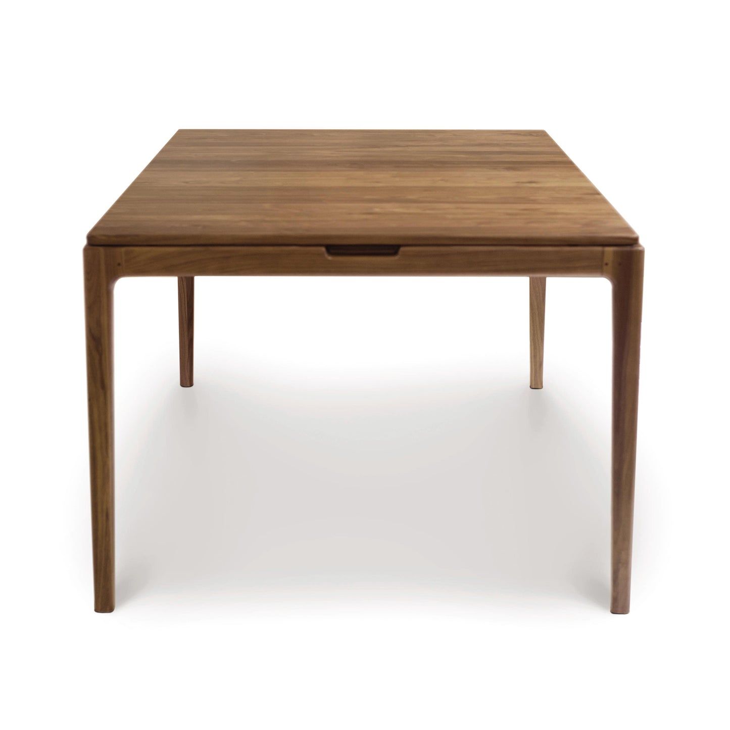 A solid walnut Lisse Extension Dining Table by Copeland Furniture with square top and four legs, isolated on a white background.