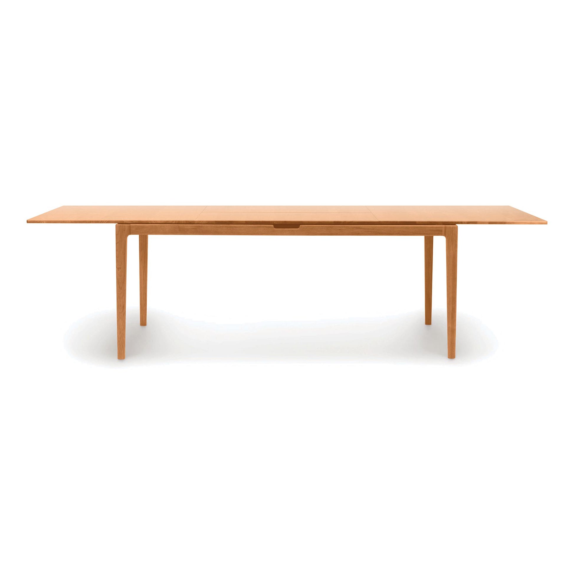 Lisse Extension Dining Table by Copeland Furniture in solid walnut, featuring a rectangular top, clean lines, and four straight legs.