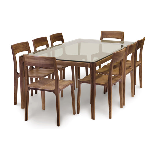A modern dining set by Copeland Furniture with a minimalist design, featuring a Lisse Glass Top Dining Table and eight wooden chairs on a white background.
