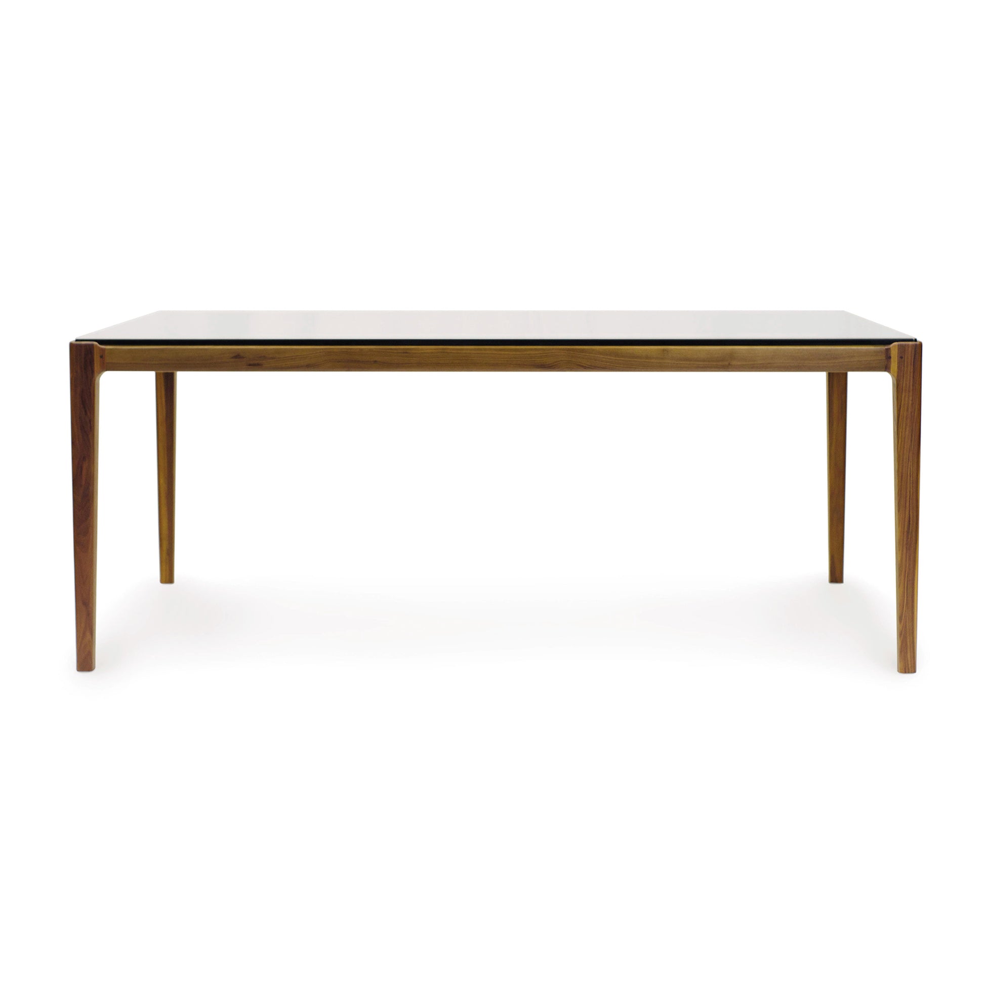 A natural walnut Lisse Glass Top Dining Table by Copeland Furniture with a minimalist design and a glass top.