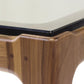 Close-up view of the corner of a Copeland Furniture Lisse Glass Top Dining Table with a black trim supporting a glass plate.